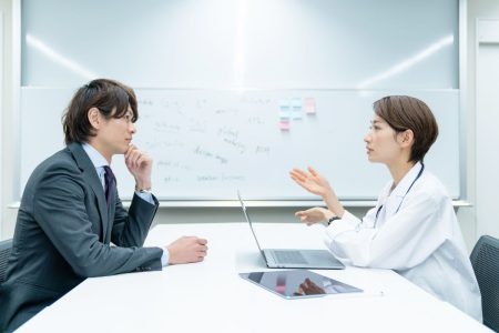 Médecin en conversation avec un homme d'affaires dans un bureau